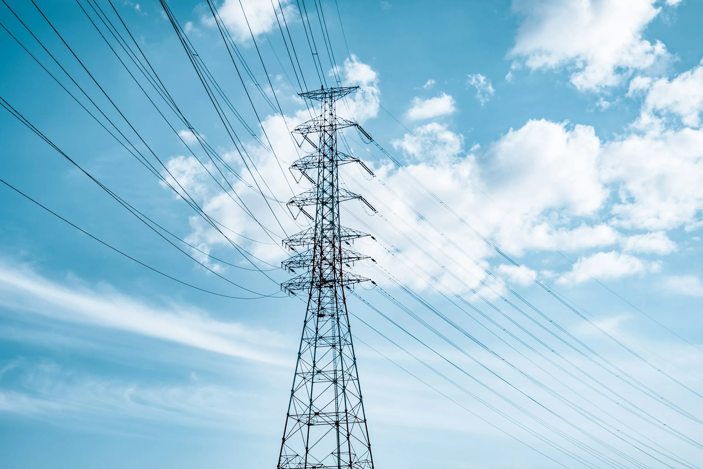 Transmission tower and power lines against the sky